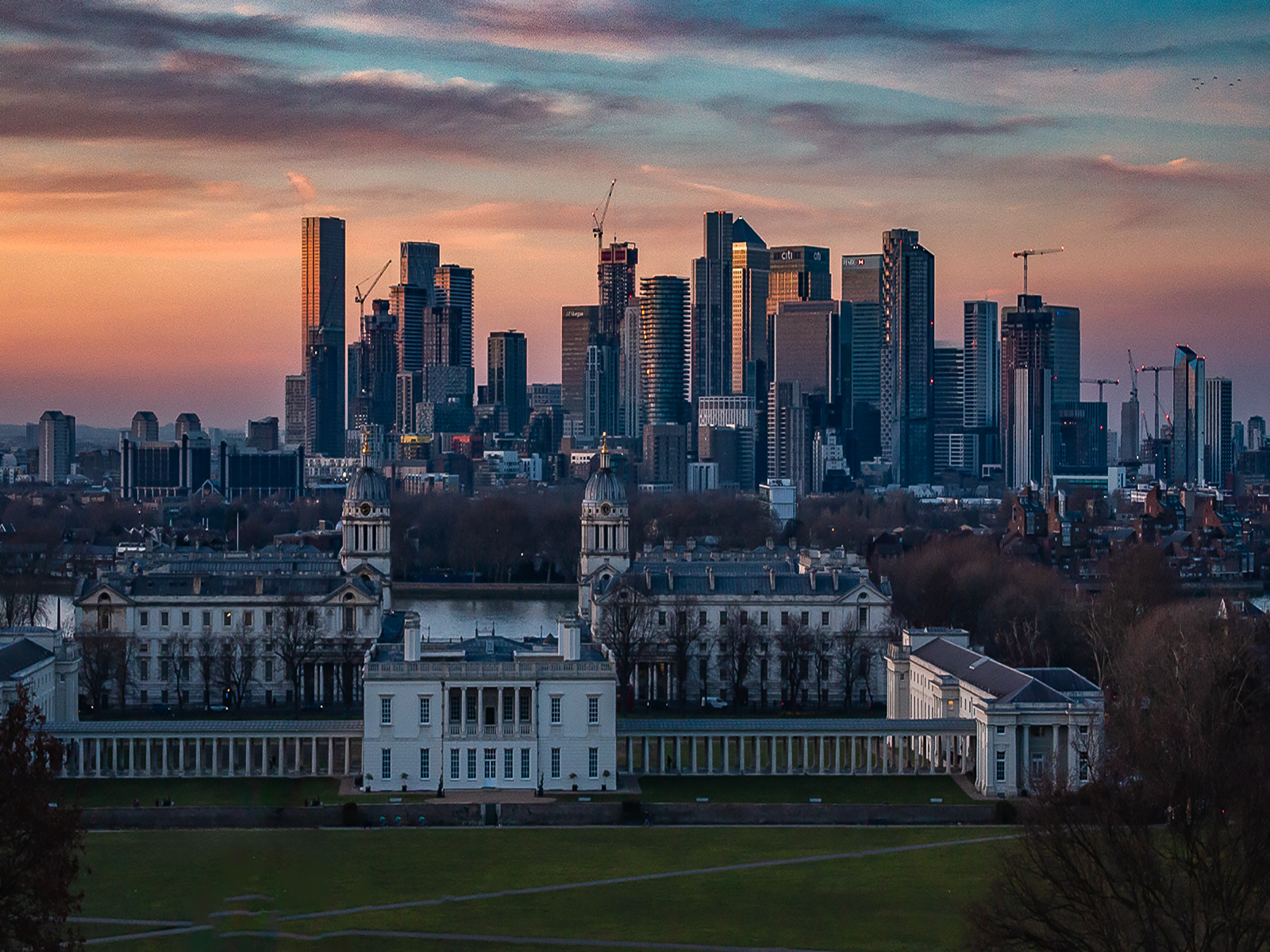 Evening At Greenwich Naval College And Canary Wharf by John Scott