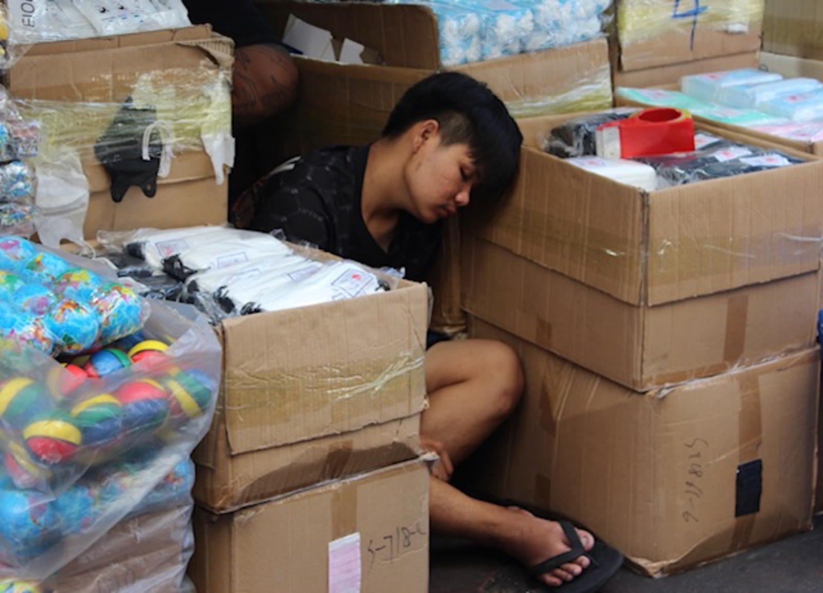 Stealing A Nap In The Box Room - Bangkok by Anne Young