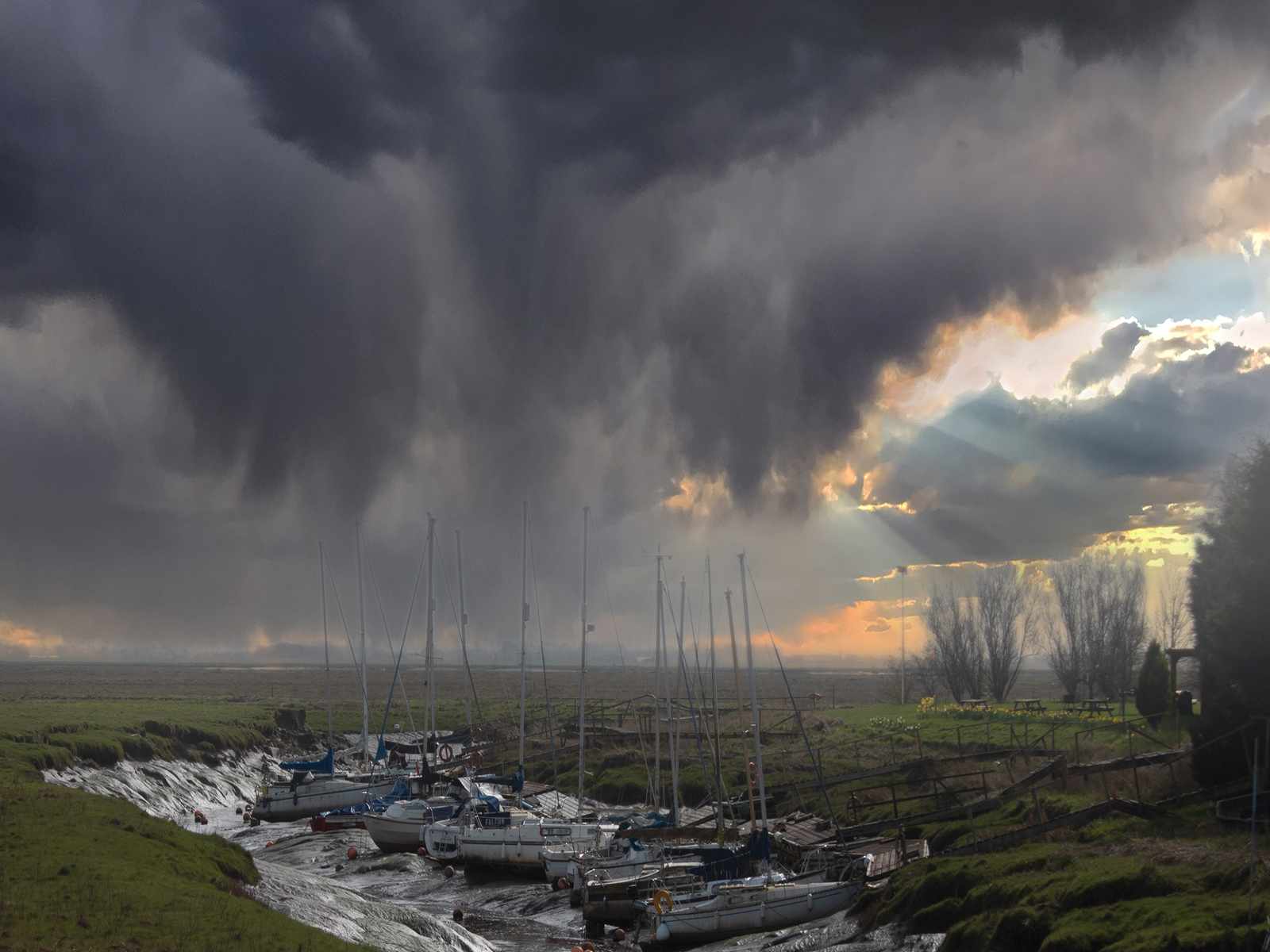 Storm Clouds Over The Wyre Brook Lytham by John Scott