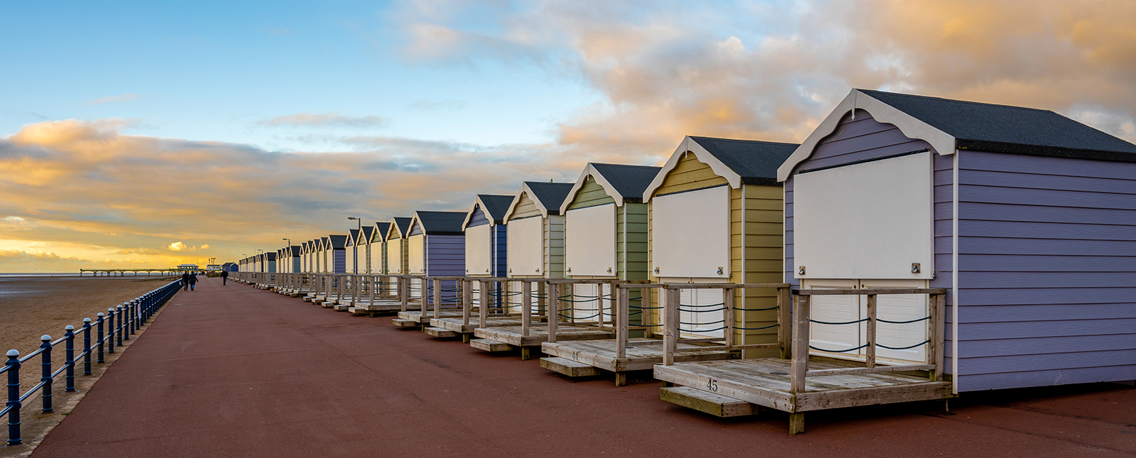 Beach Huts And Pier by Brian Cackett